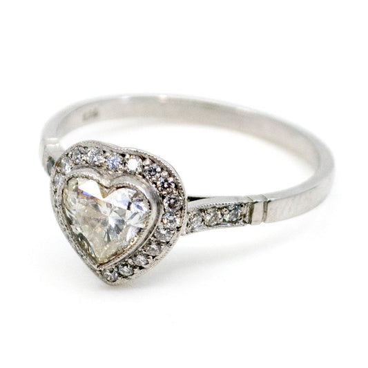 A heart shaped diamond cluster ring in platinum, with diamond shoulders