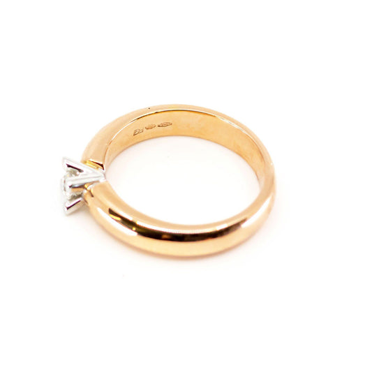 A single stone diamond ring in yellow and white gold