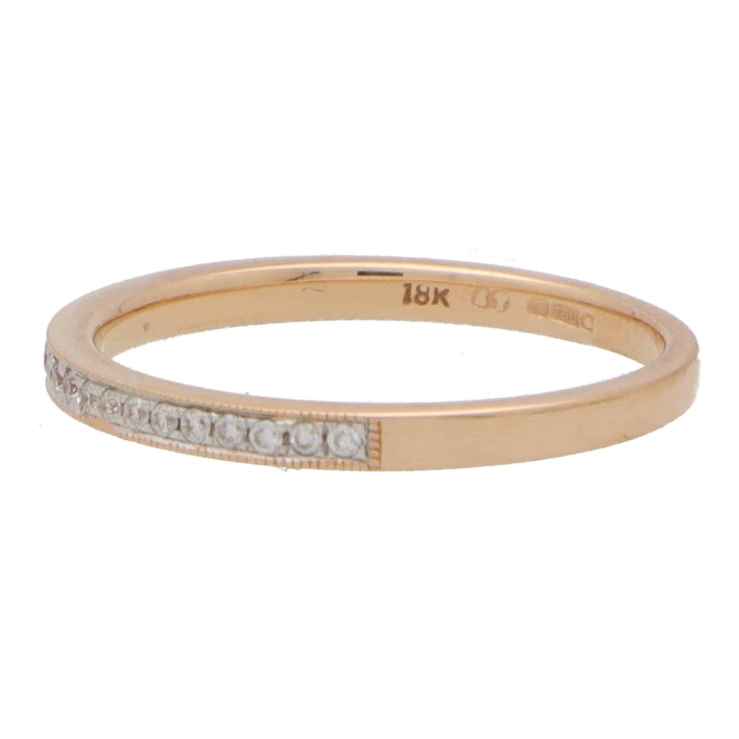 A rose gold diamond set half eternity band ring, stamped 18K, on a white background