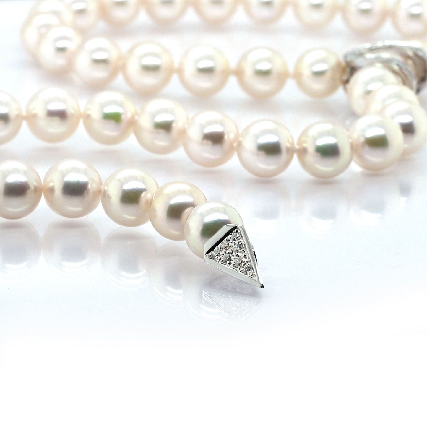 A pearl necklace with a white gold diamond set clasp