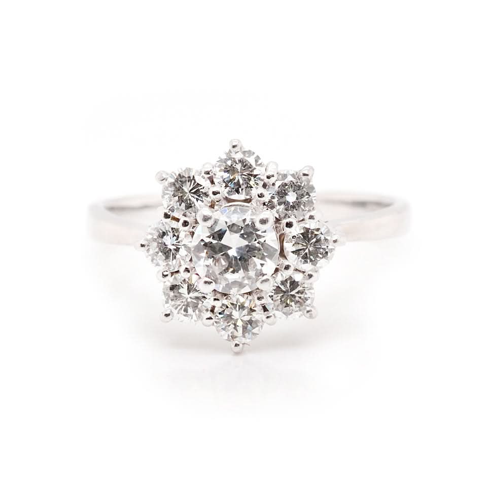 A white gold round cut diamond floral cluster ring