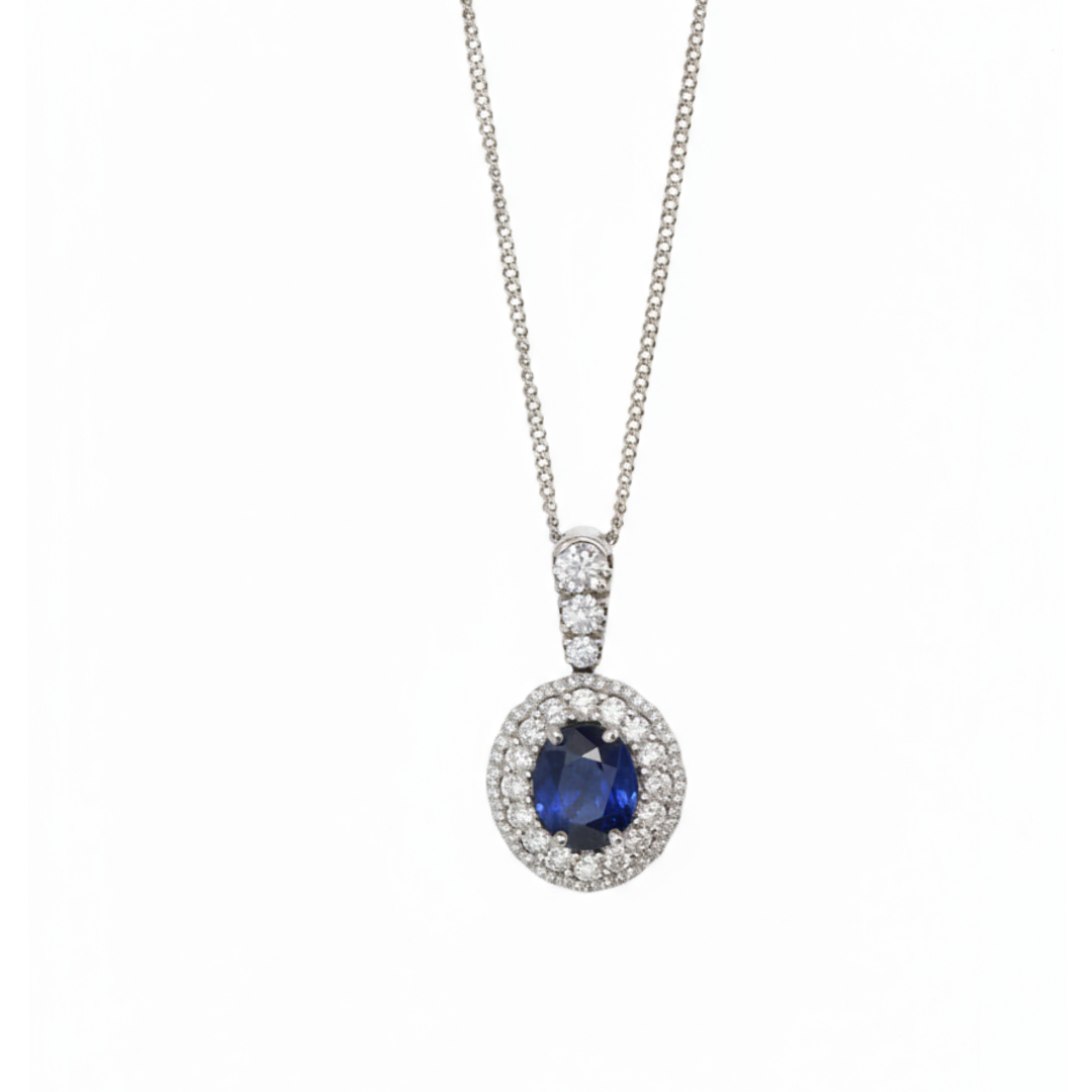 An oval cluster pendant with a sapphire centre and diamond surround, in white gold, with a white gold chain