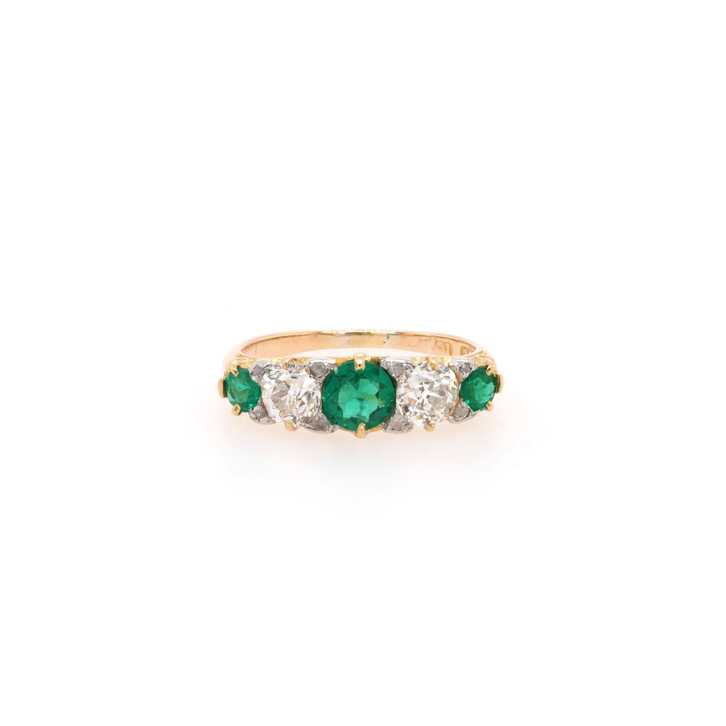 A yellow gold graduated ring with three emeralds and two diamonds
