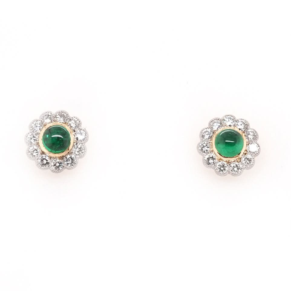 A pair of floral cluster earrings with emeralds and diamonds in gold