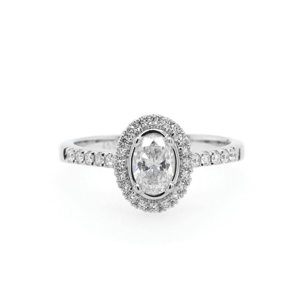 Jewellery A Platinum Oval Diamond Cluster Ring with Diamond Shoulders