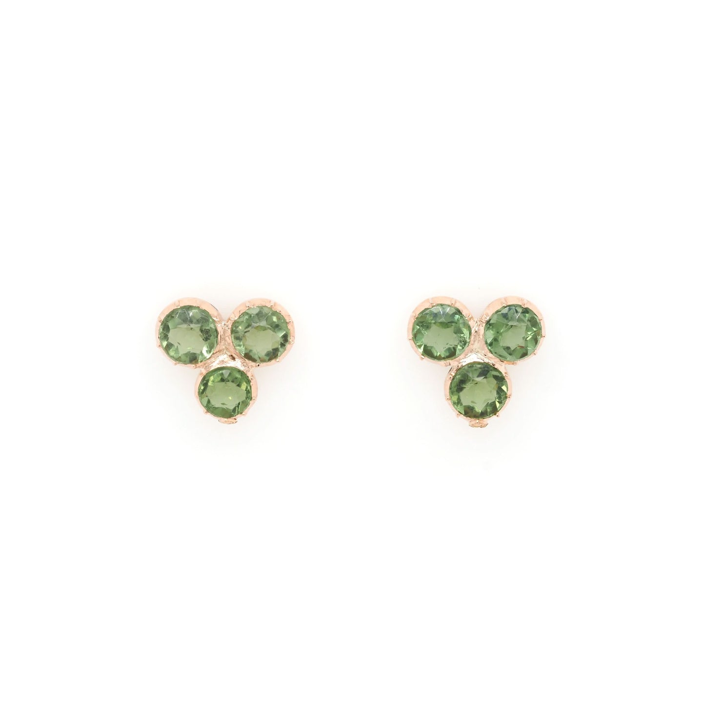 A pair of three stone peridot earrings in yellow gold