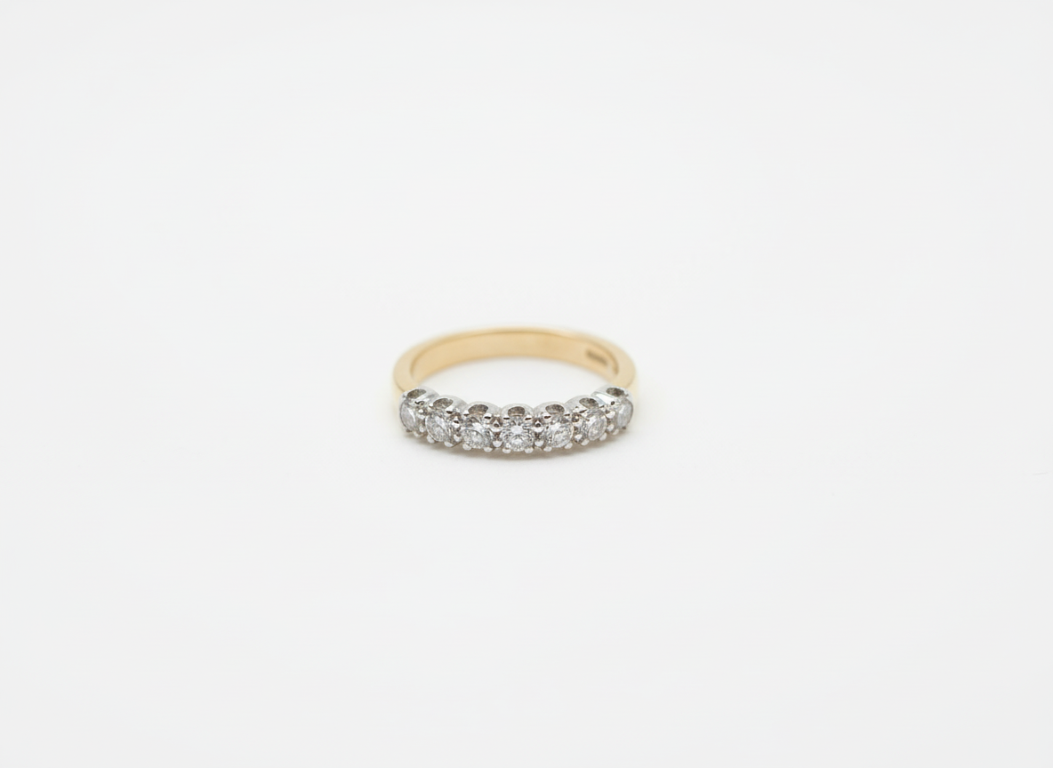 A yellow and white gold brilliant cut diamond half eternity ring