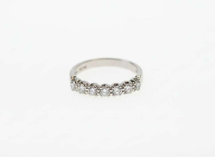 A seven stone brilliant cut diamond half eternity ring in platinum