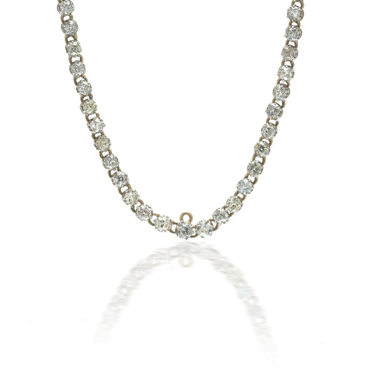 An antique diamond riviere necklace in yellow gold