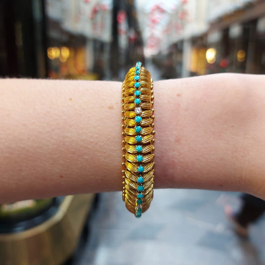 Vintage 1960s Yellow Gold Bracelet with Turquoise and Diamonds; handcrafted 18ct yellow gold bracelet with 3D textured leaf design and central row of cabochon turquoise alternating with 0.30cts round brilliant-cut diamonds, accented with borders of spherical gold beads