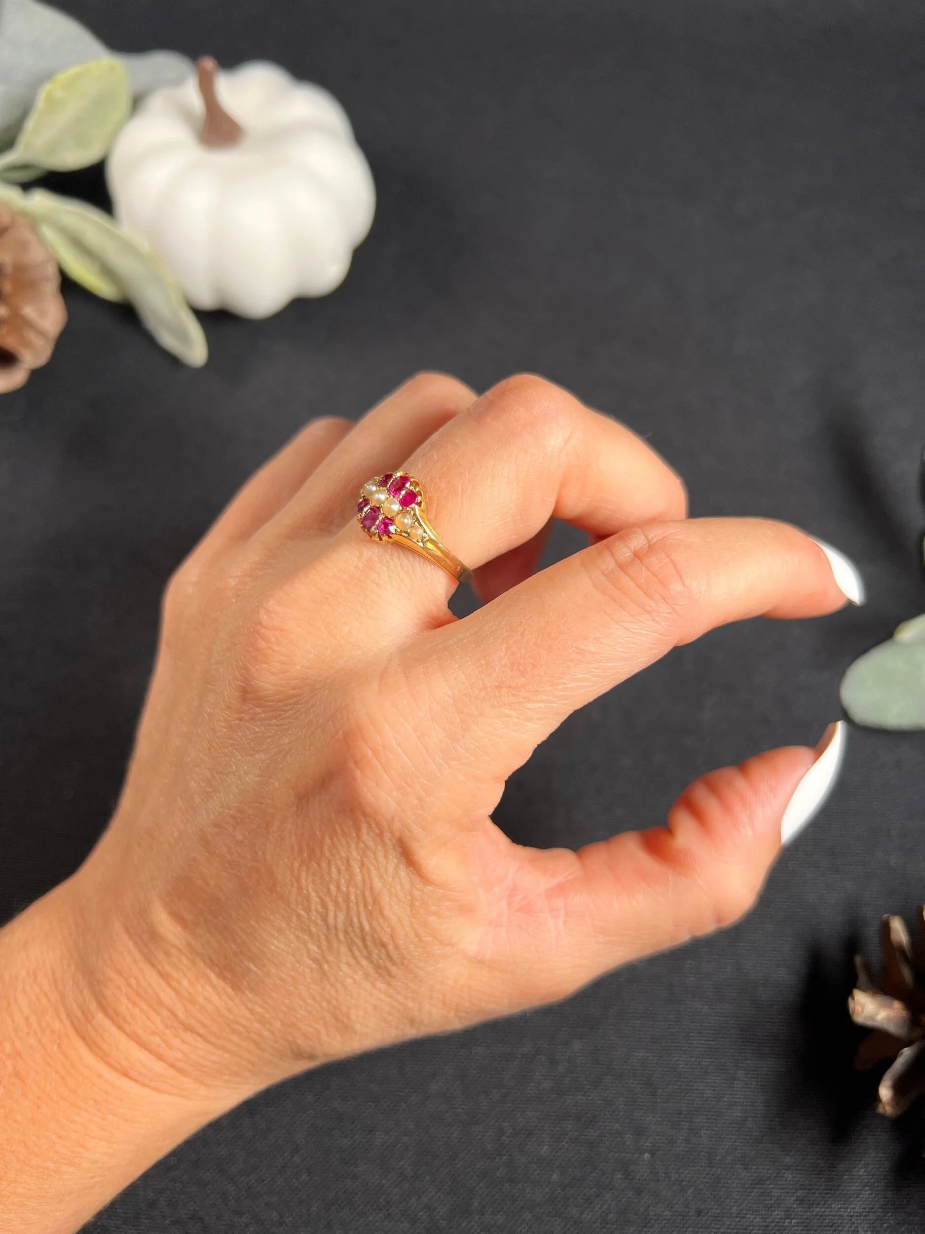 A yellow gold ruby and pearl cluster ring, modelled on a hand