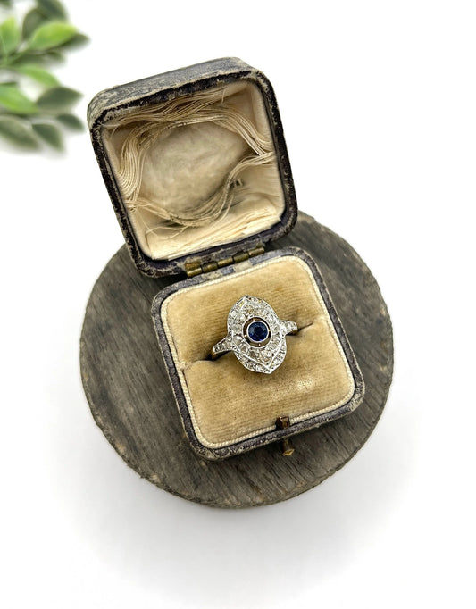 A sapphire and diamond openwork ring in platinum with a yellow gold ring shank, in an antique ring box