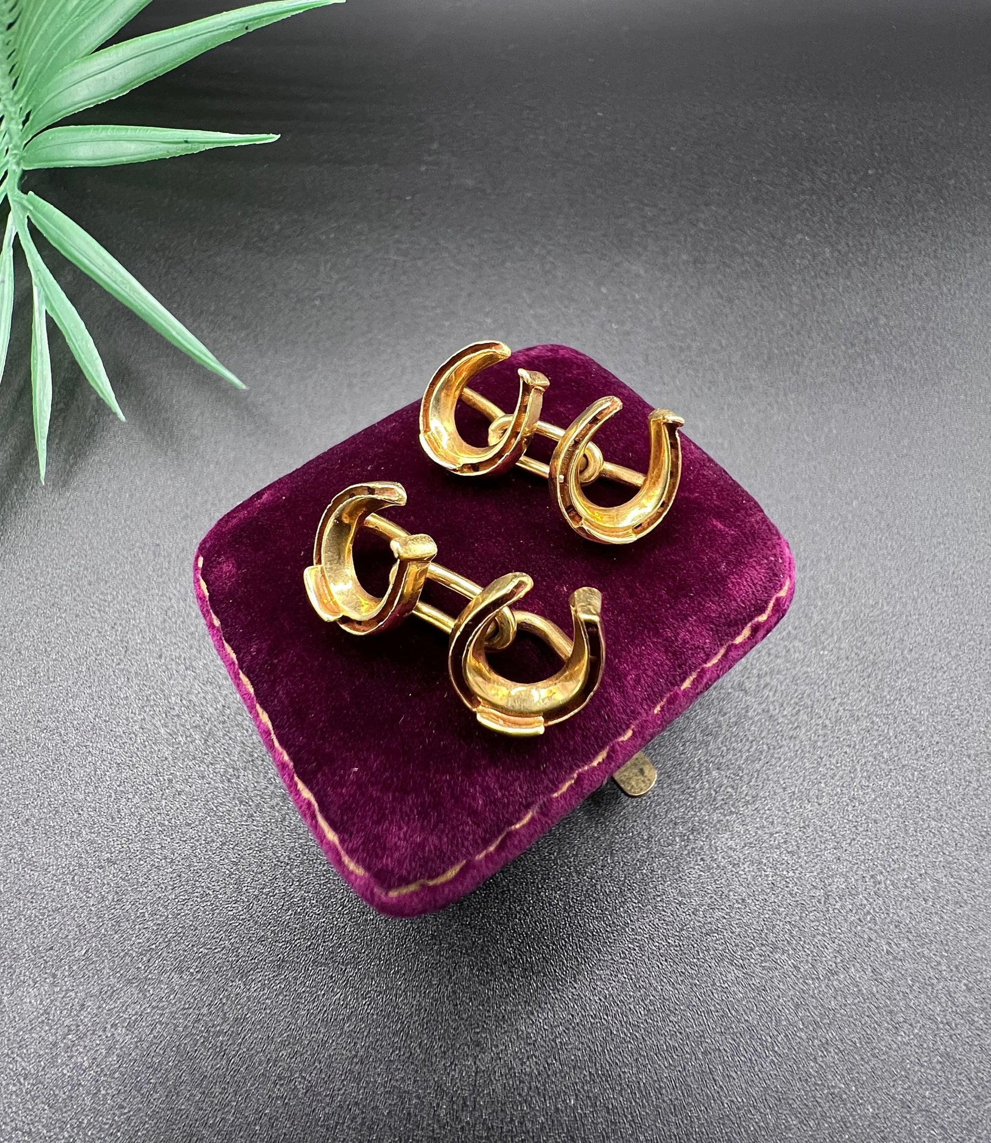 A pair of double-sided horseshoe cufflinks in yellow gold