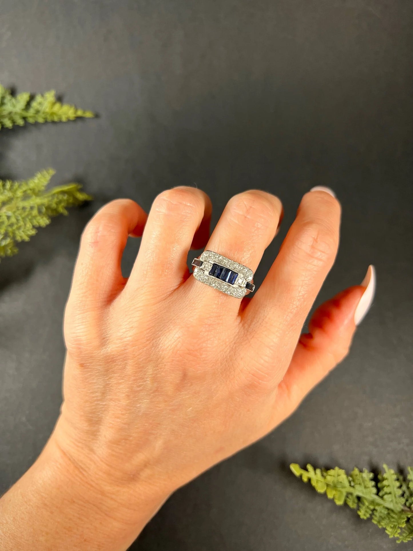 A sapphire and diamond cocktail ring in platinum, modelled on a hand