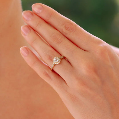 Diamond halo ring in yellow gold.