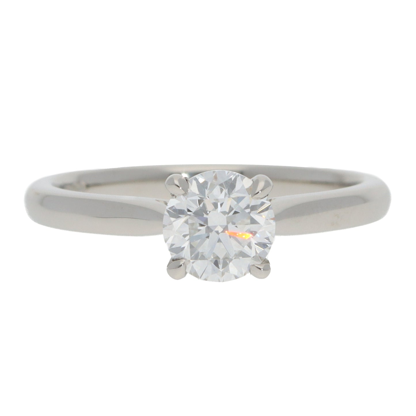 A solitaire brilliant cut diamond ring in platinum, on a white background
