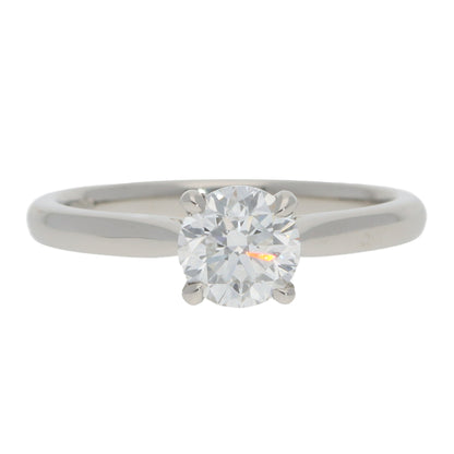 A solitaire brilliant cut diamond ring in platinum, on a white background
