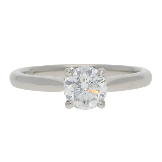 A solitaire brilliant cut diamond ring in platinum, on a white background