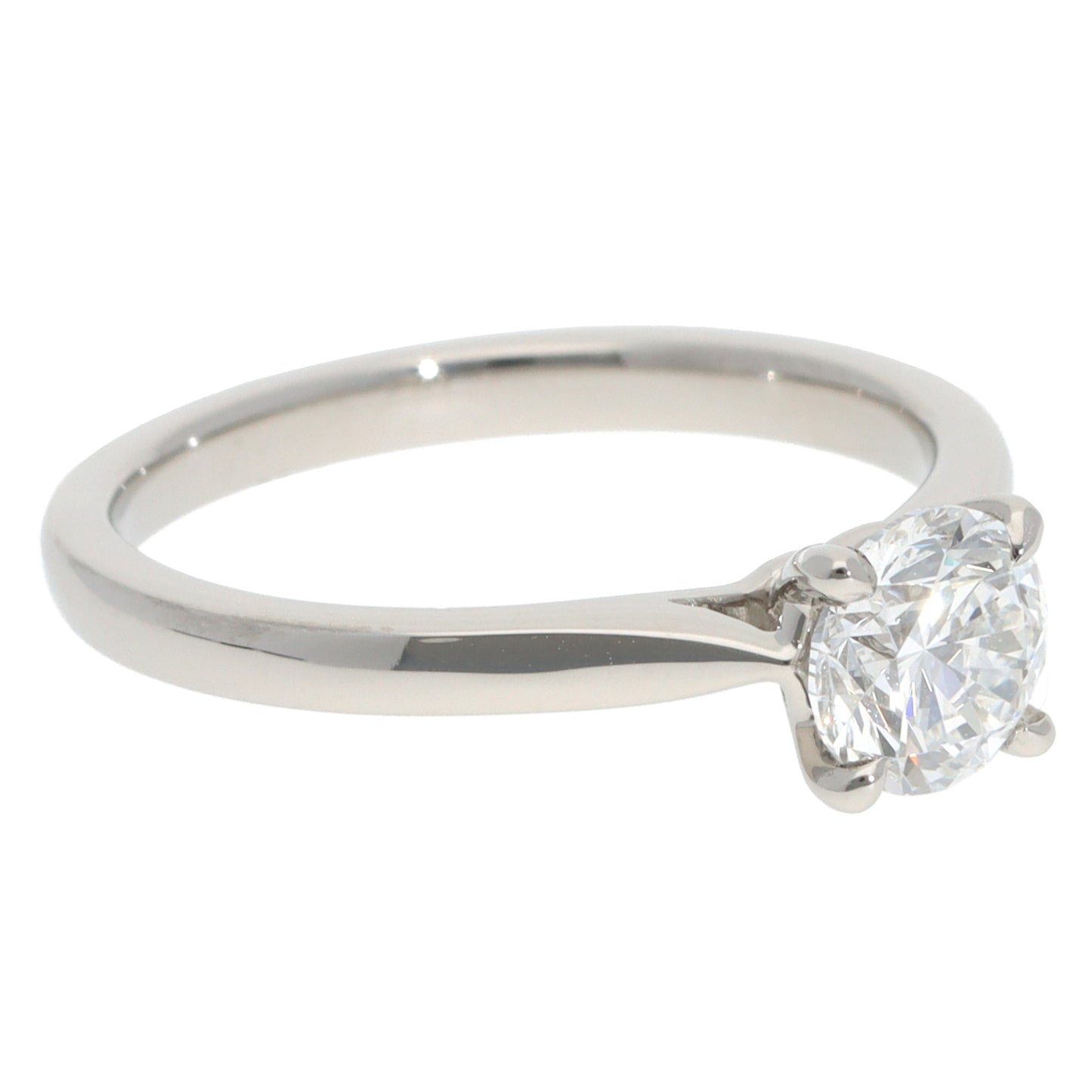 A solitaire brilliant cut diamond ring in platinum, on a white background