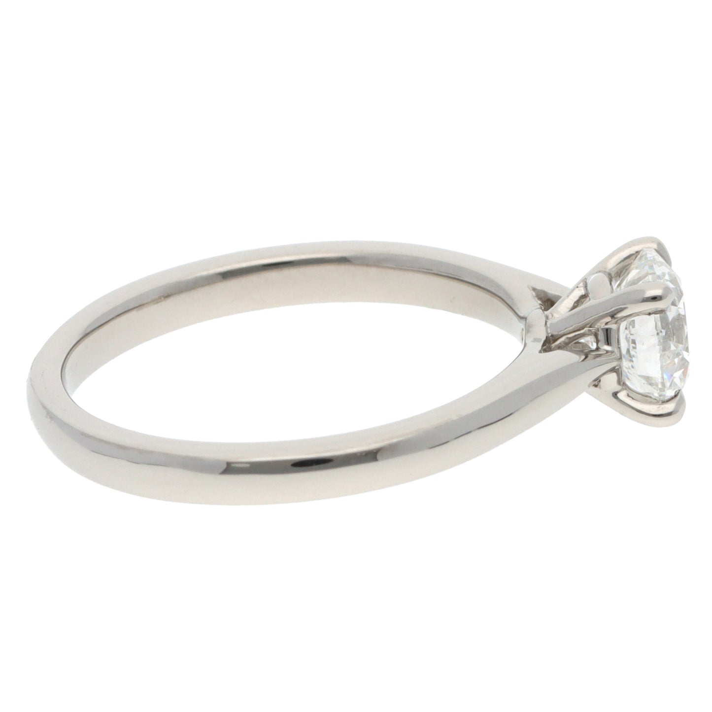 A solitaire brilliant cut diamond ring in platinum, on a white background