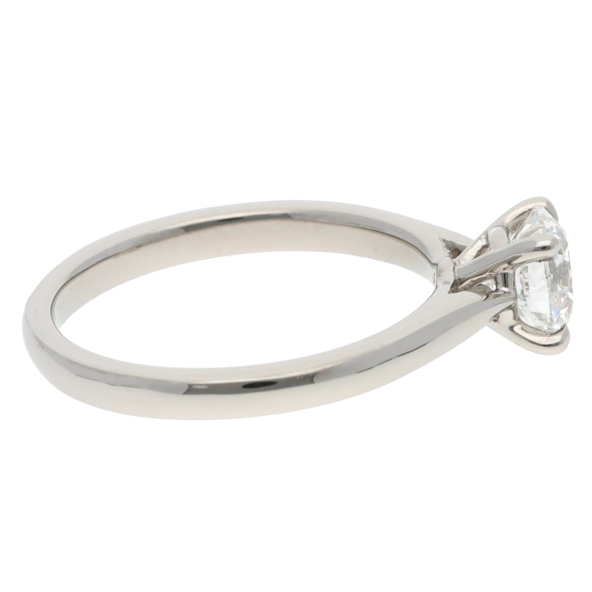 A solitaire brilliant cut diamond ring in platinum, on a white background