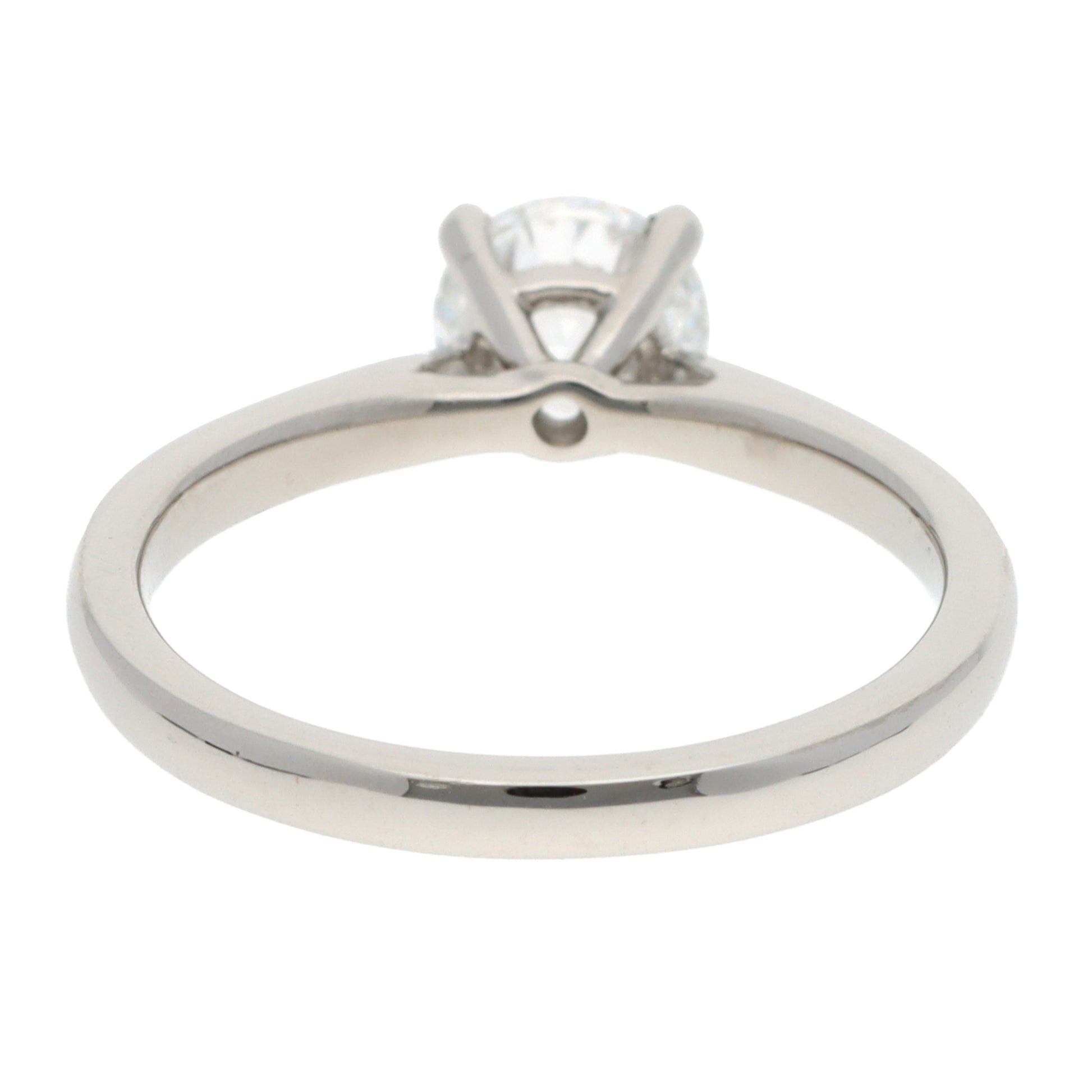 A solitaire brilliant cut diamond ring in platinum, on a white background