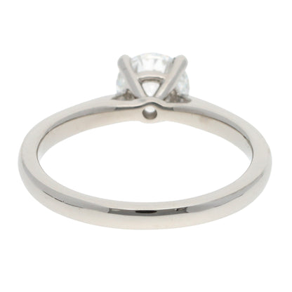 A solitaire brilliant cut diamond ring in platinum, on a white background