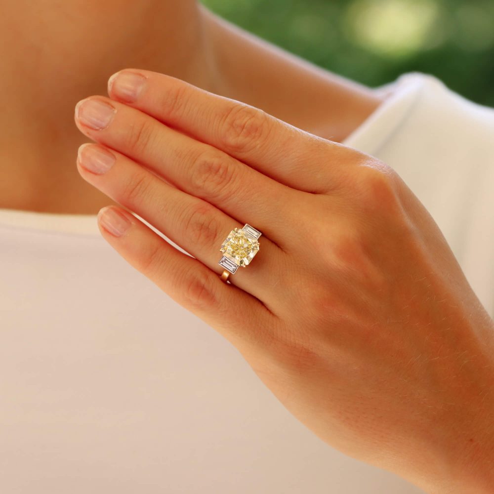 Natural 5.03 carat yellow diamond ring set in yellow gold and platinum.