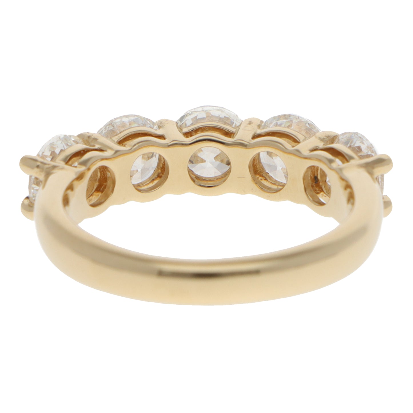 A five stone round brilliant cut diamond ring in yellow gold, on a white background