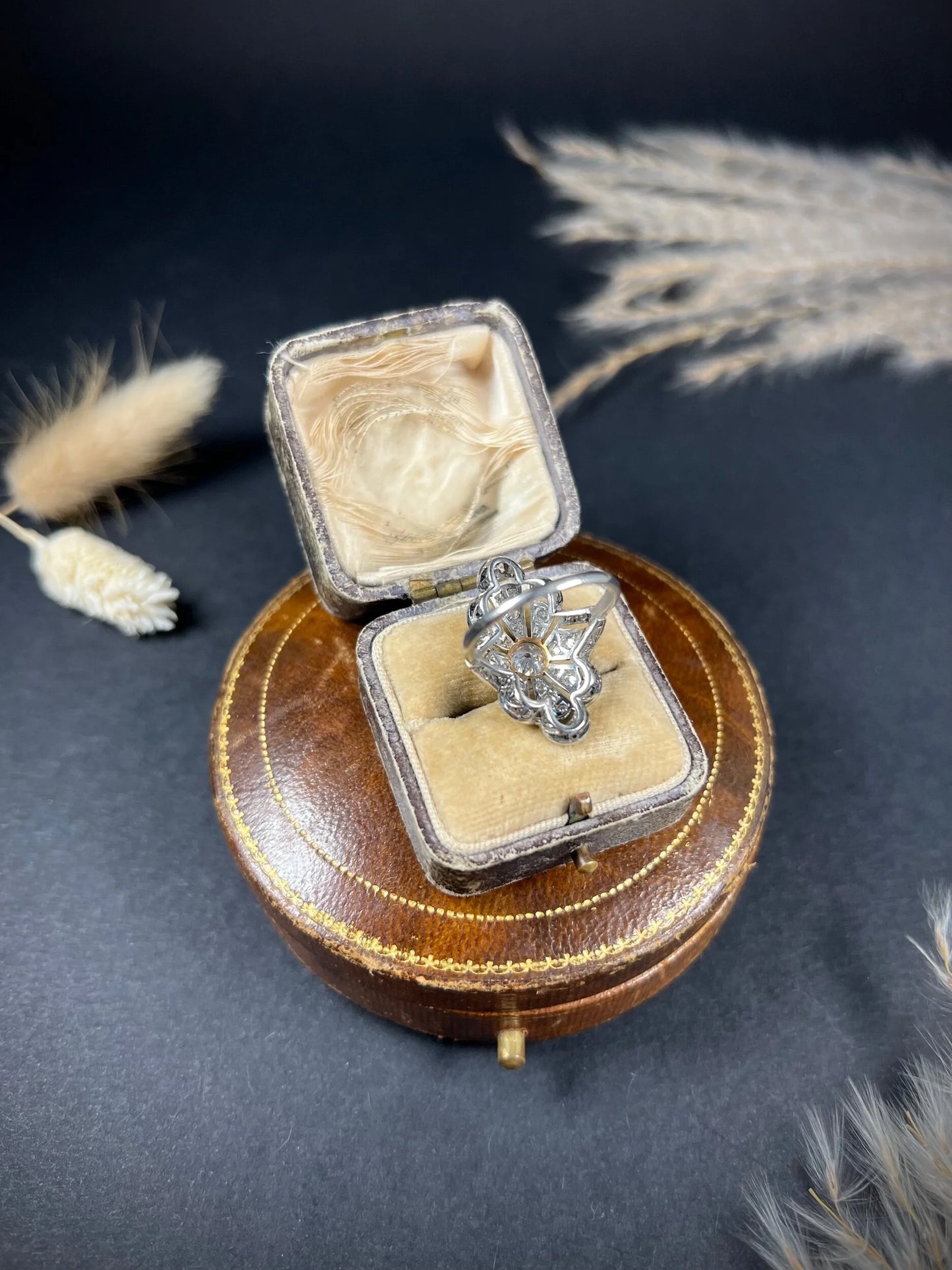 A diamond cocktail ring in white metal, in an antique ring box