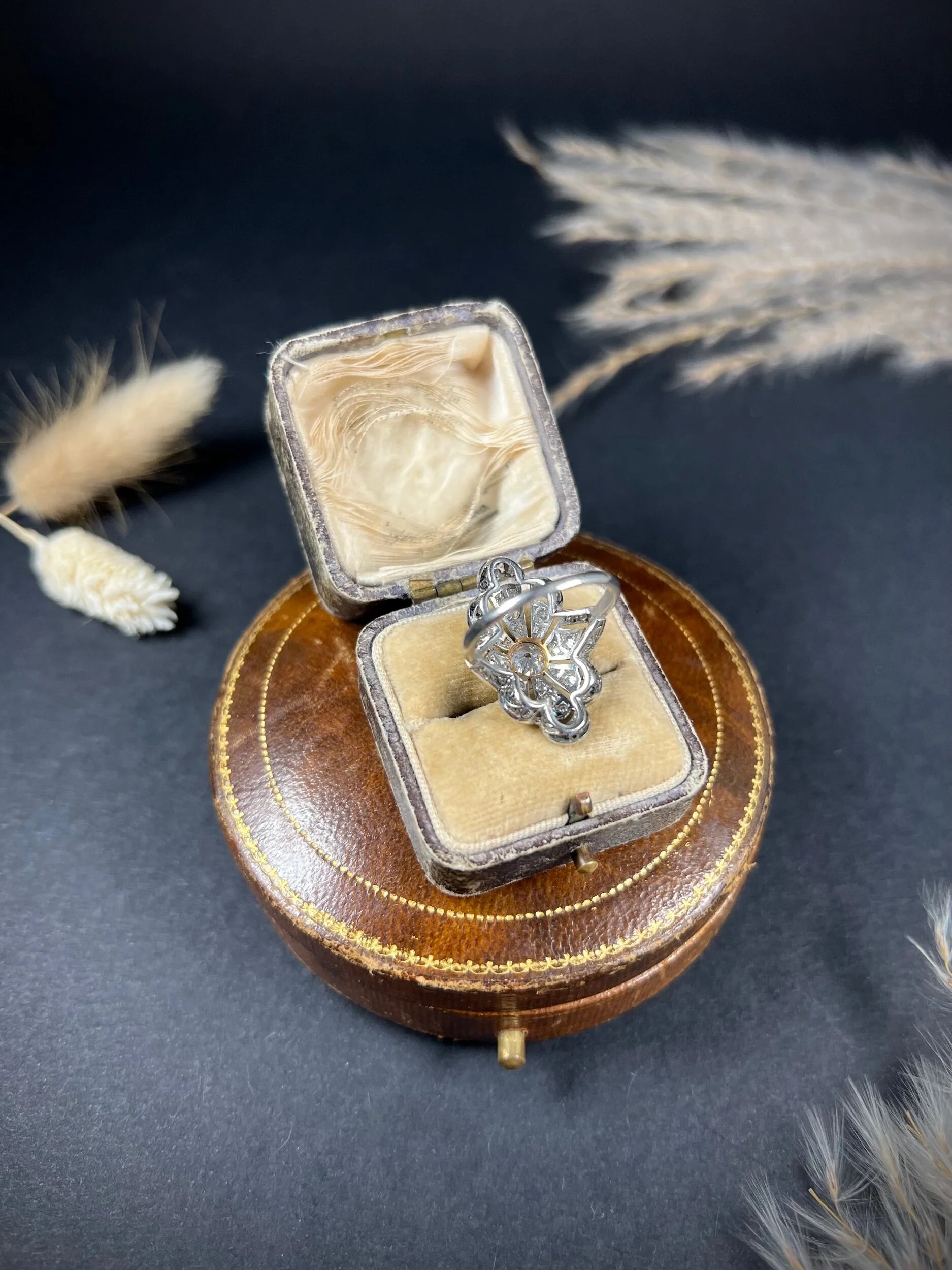 A diamond cocktail ring in white metal, in an antique ring box