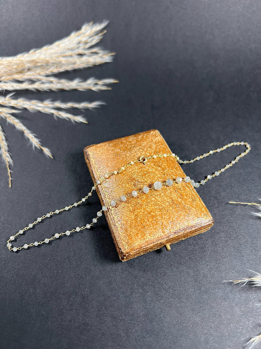 A vintage yellow gold necklace with interspersed faceted diamonds