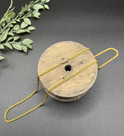 A yellow gold trace link chain necklace