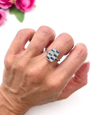 A sapphire and diamond tablet style ring in platinum, modelled on a hand