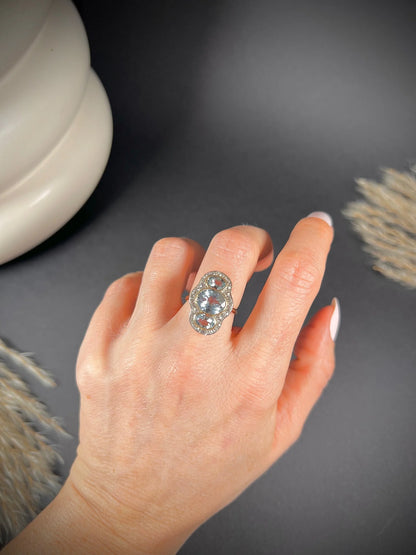 An aquamarine and diamond cocktail cluster ring, modelled on a hand