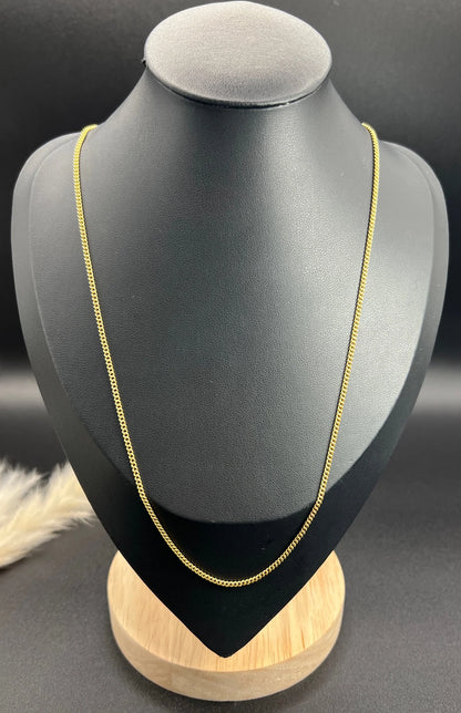 A fine curb link chain necklace in yellow gold