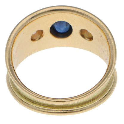 A yellow gold three stone band ring on a white background