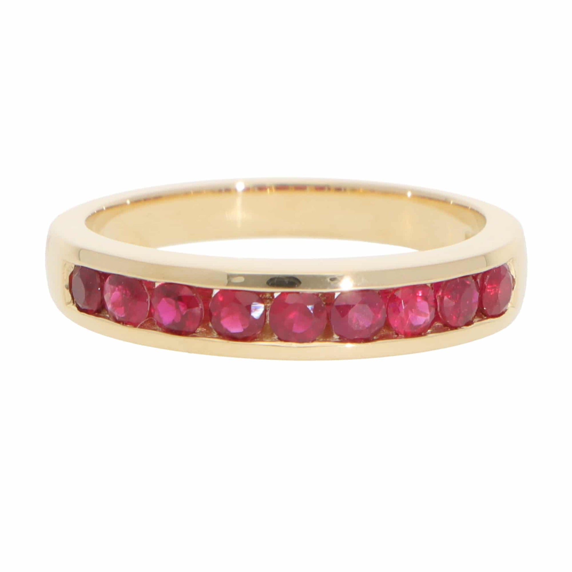 A yellow gold half eternity band with round rubies, on a white background