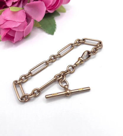 A rose gold link bracelet with a T-bar