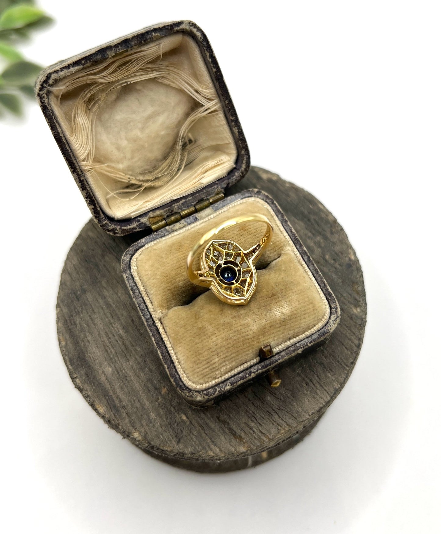 A sapphire and diamond openwork ring in platinum with a yellow gold ring shank, in an antique ring box