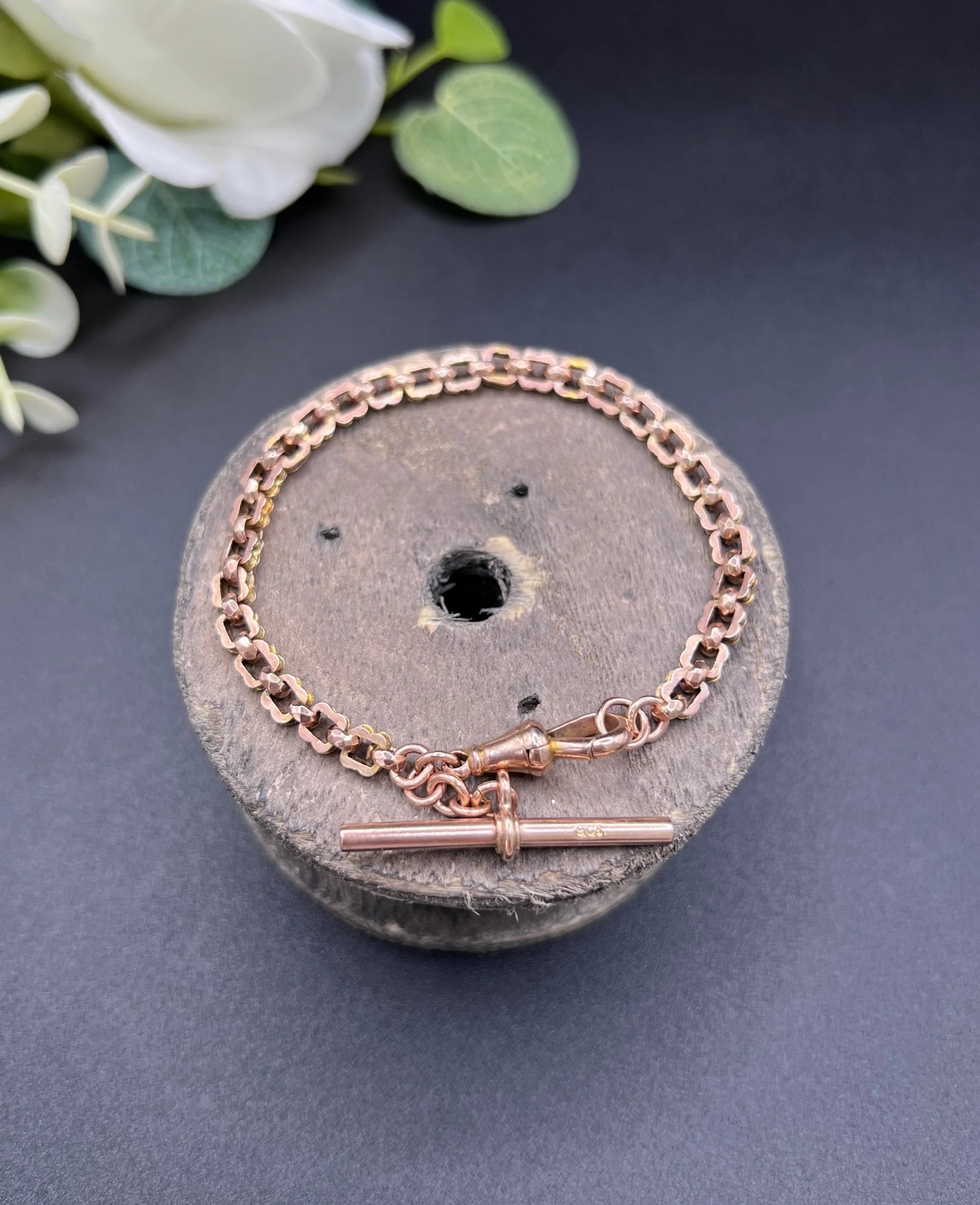 A fancy link rose gold bracelet with a T-bar and dog clip clasp