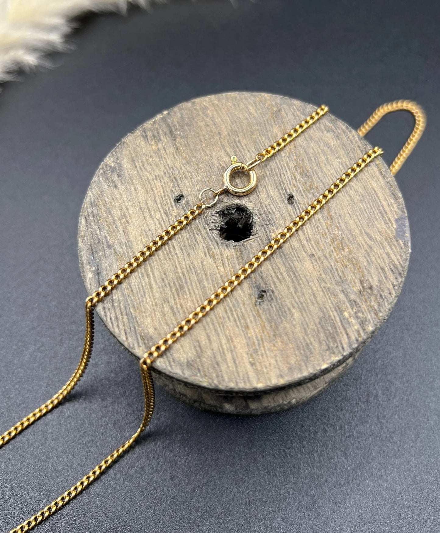 A fine curb link chain necklace in yellow gold