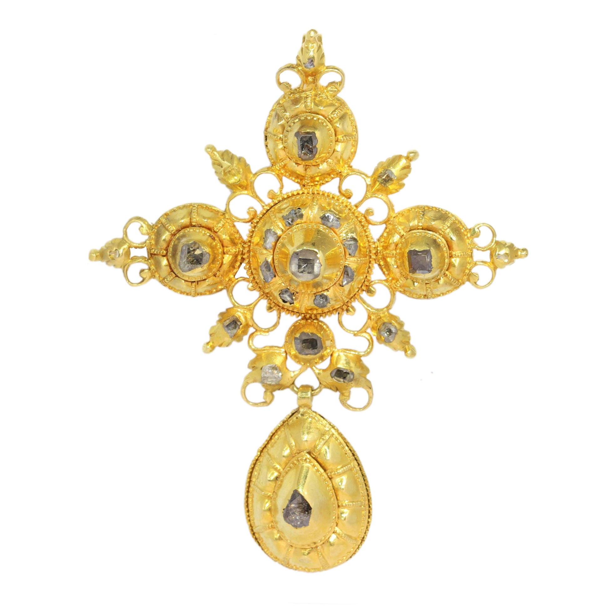 An ornate yellow gold cross pendant with table cut diamonds