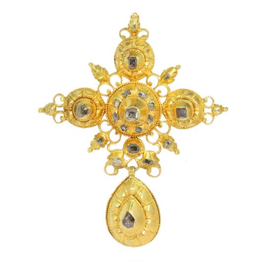 An ornate yellow gold cross pendant with table cut diamonds