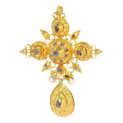 An ornate yellow gold cross pendant with table cut diamonds