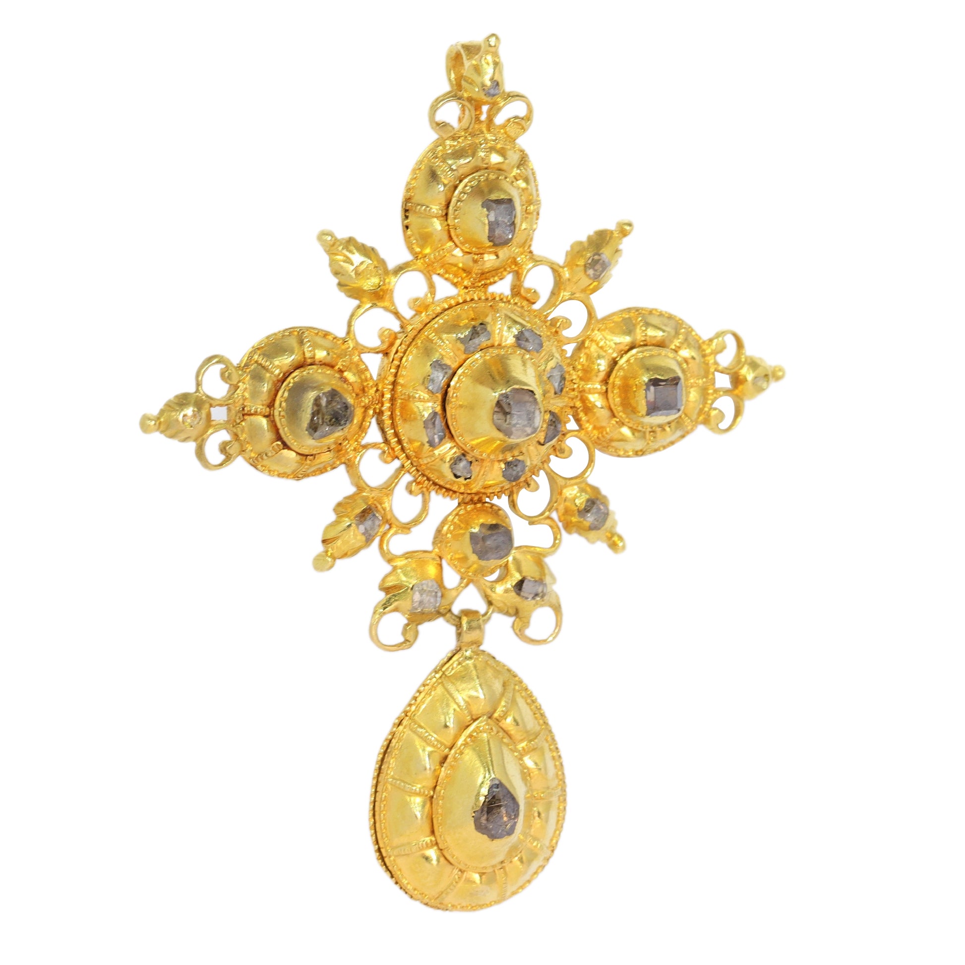 An ornate yellow gold cross pendant with table cut diamonds