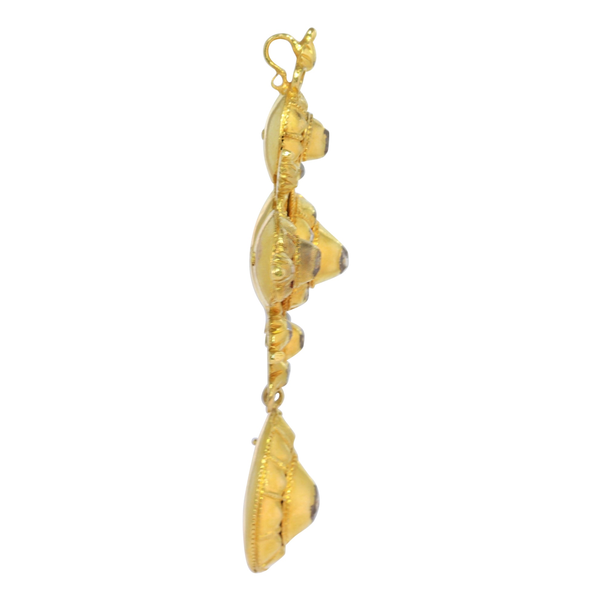 An ornate yellow gold cross pendant with table cut diamonds