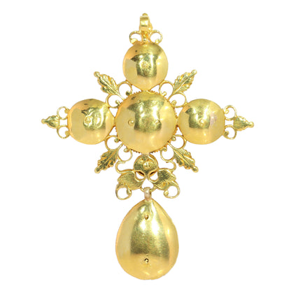 An ornate yellow gold cross pendant