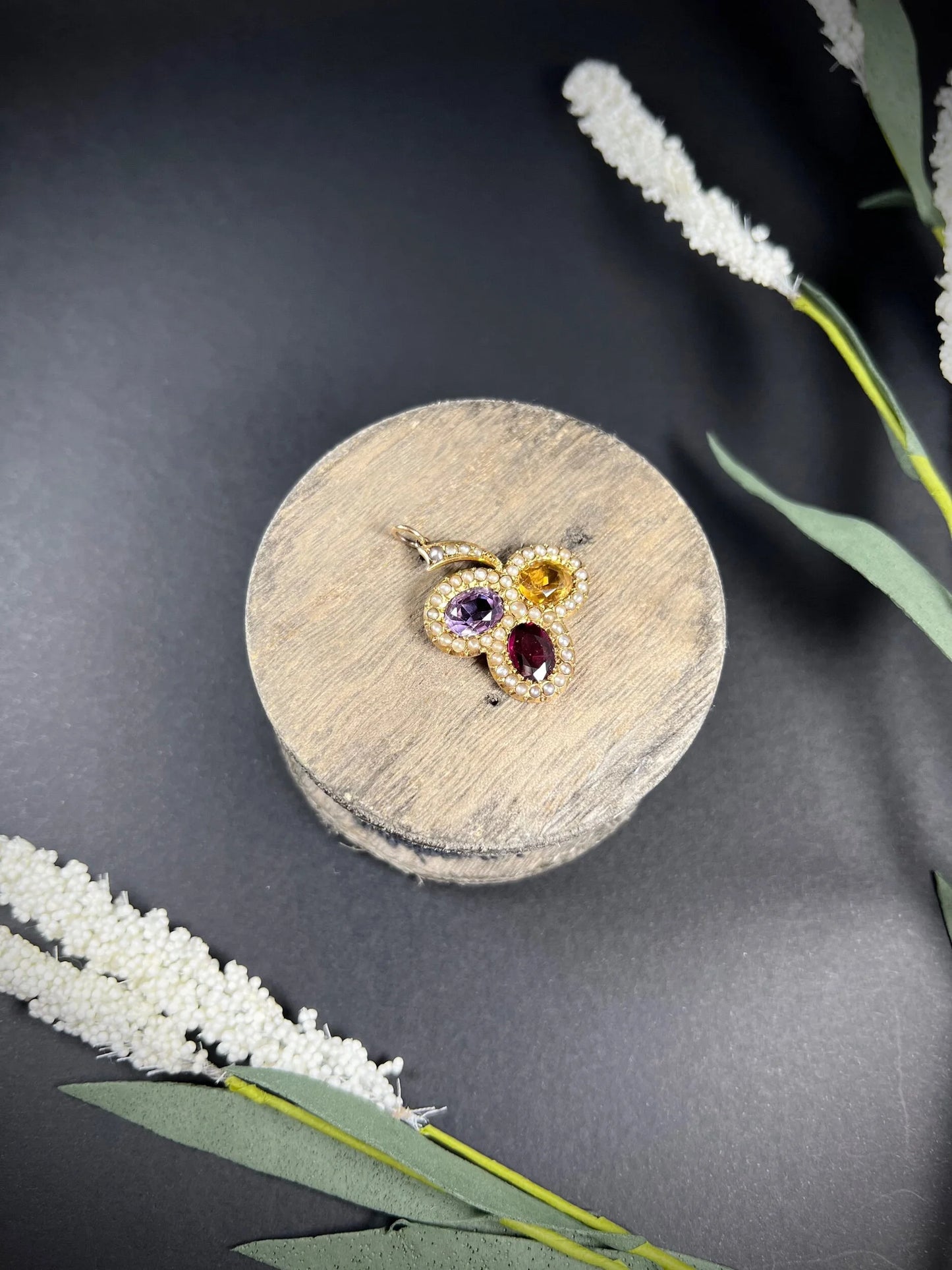 A yellow gold clover pendant with amethyst, citrine, garnet and seed pearls