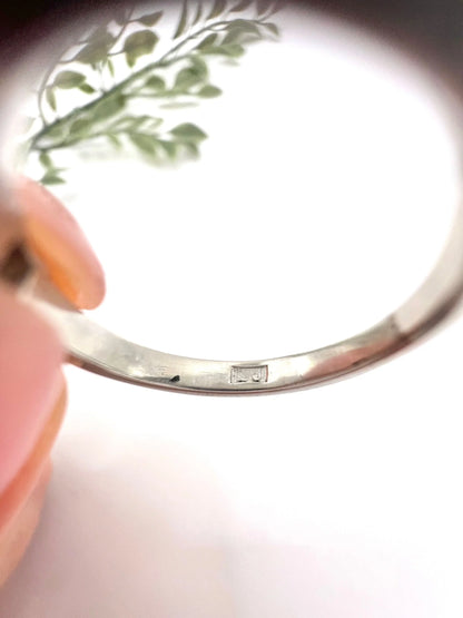 Close-up of maker's mark inside a platinum ring shank